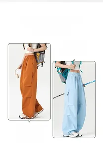 Detail of outdoor cargo pants showing elastic drawstring waist and side zipper pockets