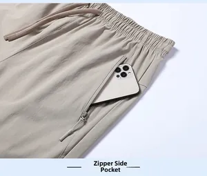 Detail of light khaki ice silk pants featuring a secure zipper pocket with a smartphone inside