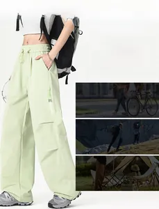 Waterproof mint green hiking pants with elastic waist and side zip pockets detail