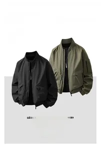 Detail of bomber jacket utility arm pocket and ribbed cuffs in black and olive green