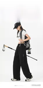 Detail view of black outdoor cargo pants featuring multi-pockets and waterproof fabric