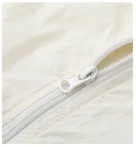 Close-up of a high-quality smooth zipper on a white sun protection jacket for men