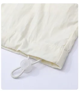 Detail of adjustable elastic hem with transparent toggle on summer sun protection jacket