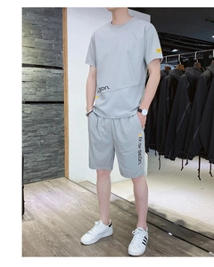 Detail view of light gray ice silk summer set showing t-shirt hem and shorts text print