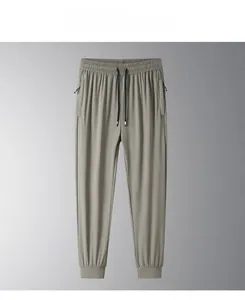 Detail of men's ice silk joggers showing micro-grid texture and side zipper pockets