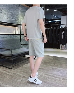 Detail view of men's summer ice silk t-shirt and drawstring shorts set in pale bean green