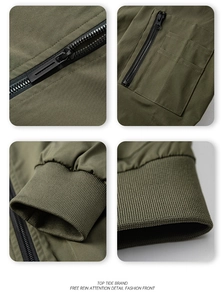 Detailed close-up of military green jacket metal zipper, pockets, and ribbed cuffs