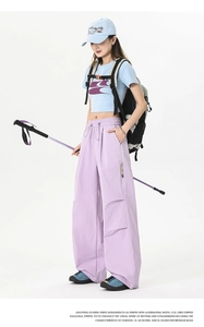 Detail of lavender outdoor cargo pants showing elastic drawstring waist and zip pockets