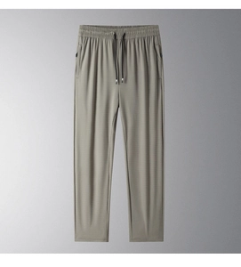 Detail of light grey-green ice silk pants showing elastic waist and zipper pockets