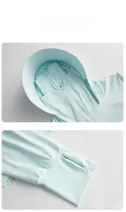 Detail of light blue sun protection jacket with oversized hood and thumbhole cuffs