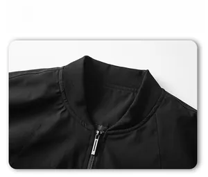 Detail view of the black jacket's ribbed stand collar and durable metal zipper closure