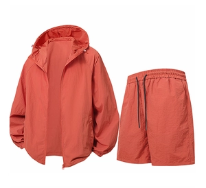 Flat lay detail of a brick red hooded sun protection jacket and shorts set for men
