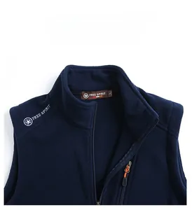 Detail of dark blue fleece vest featuring stand collar and Free Spirit embroidery