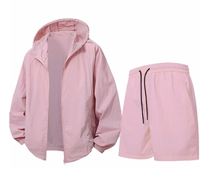 Detail of pink two-piece sun protection sports set with hooded jacket and drawstring shorts