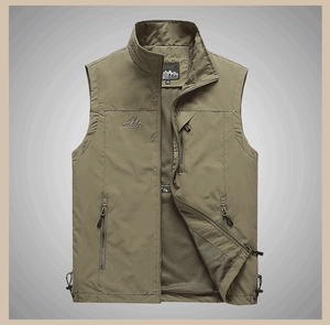 Close-up of olive green outdoor vest featuring zipper pockets and breathable mesh lining