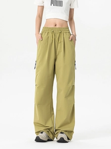 Olive green loose-fit tactical cargo pants with drawstring waist and zipper pockets