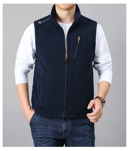 Detail of navy blue fleece vest showing stand-up collar and secure zippered chest pocket