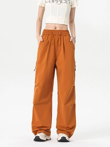 Orange high-waisted wide-leg cargo pants with double drawstring and utility stitching