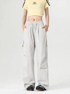 Loose fit light grey cargo pants with drawstring waist and zipper details for outdoor style