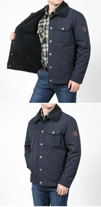 Detail of navy blue winter jacket featuring thick black fleece lining and front utility pockets