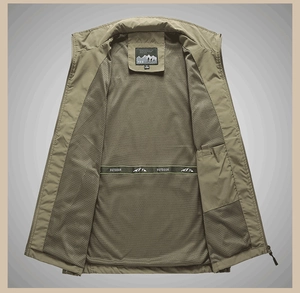 Detail of olive green outdoor vest showing breathable mesh lining and inner pocket