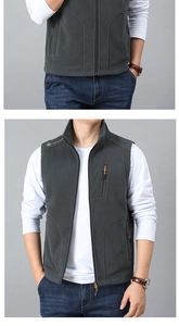 Detail view of men's dark gray fleece vest featuring stand-up collar and zippered pockets
