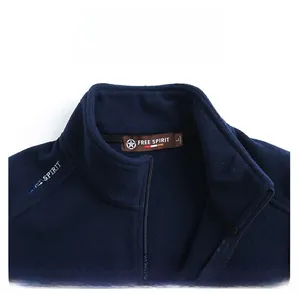 Detail of navy fleece vest stand collar featuring Free Spirit embroidery and zipper