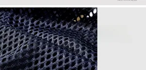 Detailed close-up of black breathable honeycomb mesh fabric for tactical vest