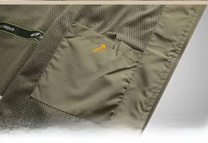 Detail view of military green vest with breathable mesh lining and a secure velcro inner pocket