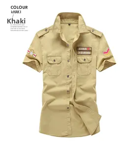 Close-up of khaki military style shirt showing buttoned chest pockets and embroidery