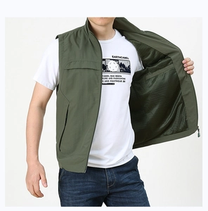 Detail of dark green outdoor vest featuring breathable mesh lining and a secure zipper pocket