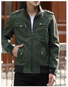 Detail of army green utility jacket showing ribbed cuffs and multi-pocket canvas texture