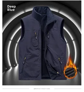 Detail of blue reversible fleece vest with four zipper pockets and stand collar