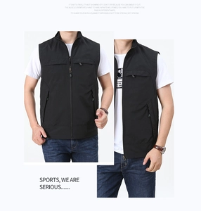 Detail view of black multi-pocket outdoor vest featuring functional zippers and stand collar