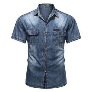 Men's short sleeve denim shirt in washed indigo blue with dual flap pockets and classic fit