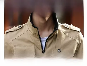 Detail view of khaki work jacket featuring ribbed stand collar and shoulder epaulettes