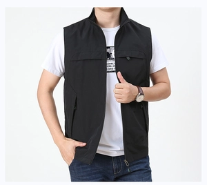 Detail of men's black functional vest featuring stand collar and zipper pockets