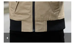 Detail of khaki jacket showing ribbed hem and reinforced double stitching with black zipper