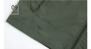 Detail view of the deep green quick-dry vest showing hem stitching and zipper quality
