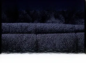Macro shot of thick black fleece lining for winter coat showing soft texture and density