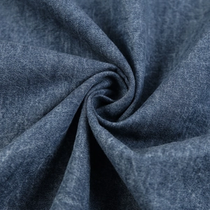 Detailed macro view of dark blue denim fabric texture with twill weave pattern