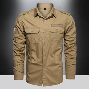 Detail view of khaki tactical shirt showing shoulder epaulets and chest pocket with embroidery
