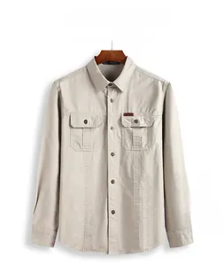 Detail of light khaki long-sleeve utility shirt with symmetric flap pockets and button-down front