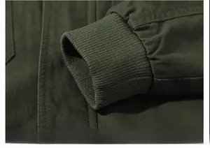 Macro shot of durable olive green cotton canvas jacket showing ribbed elastic cuffs