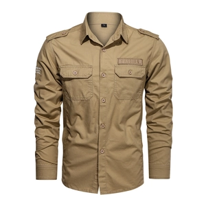 Detail of khaki military style shirt featuring shoulder epaulets and dual chest pockets