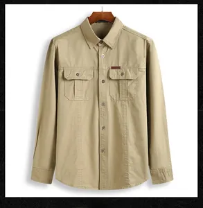 Detail of khaki cotton work shirt with double chest pockets and metal buttons