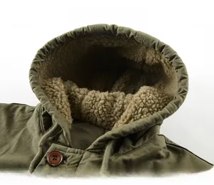 Detail of army green hooded jacket showing warm beige sherpa lining and drawstring hood