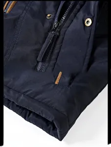 Detail of durable metal zipper and knitted cuffs on navy blue winter jacket