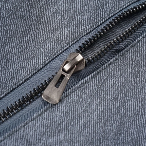 Macro shot of durable vintage zip hardware on men's stand collar gray-blue leather jacket