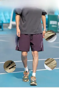 Detail showing elastic waistband with contrast drawstring and functional side pockets